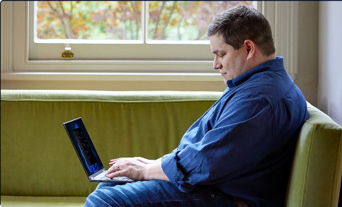 Man typing on Windows 11 laptop